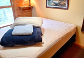 Upper level private queen bedroom with full closet and dresser in Wildflower Cabin #10 at Crow Wing Crest Lodge in Akeley, MN