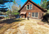 Wildflower Cabin #10 hard packed dirt parking area at Crow Wing Crest Lodge in Akeley, MN