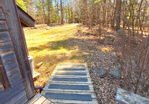 Wildflower Cabin #10 entrance ramp from hard packed dirt parking area to deck and main level at Crow Wing Crest Lodge in Akeley, MN