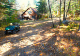 Wildflower Cabin #10 hard packed dirt parking area at Crow Wing Crest Lodge in Akeley, MN