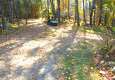 Wildflower Cabin #10 hard packed dirt parking area, room for boat or ATV trailers at Crow Wing Crest Lodge in Akeley, MN