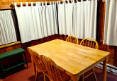 8_DiningTableAtNight2026TowardsEntranceView