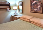 King bedroom on main level of Raspberry Cabin #9 at Crow Wing Crest Lodge in Akeley, MN