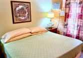 King bedroom on main level of Raspberry Cabin #9 at Crow Wing Crest Lodge in Akeley, MN
