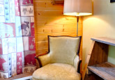 9_kingBedroomReadingChairAndLampPlusShelves