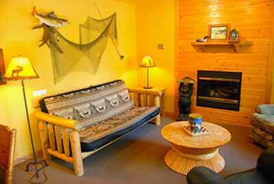 Living room with gas fireplace in Wildflower Cabin #10 at Crow Wing Crest Lodge in Akeley, MN